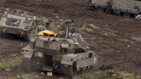 FILE PHOTO. Israeli soldiers set up their equipment near a tank near the border with Lebanon on March 15, 2026 in Northern Israel.