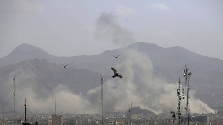 Smoke rises over the city center after an Israeli army launches a wave of airstrikes on Iran on February 28, 2026.