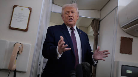 US President Donald Trump speaks to reporters on board Air Force One while he returns from the World Economic Forum on January 22, 2026.