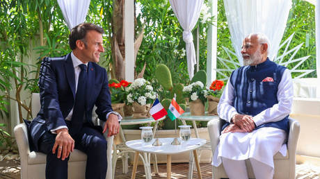 FILE PHOTO: French President Emmanuel Macron with Indian Prime Minister Narendra Modi.