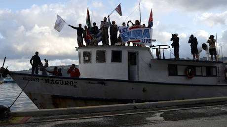 People celebrate the arrival of the first ship of the humanitarian convoy in solidarity with Cuba, in Havana on March 24, 2026