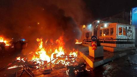 A police station is set on fire during protests in Tehran, Iran on January 10, 2026.