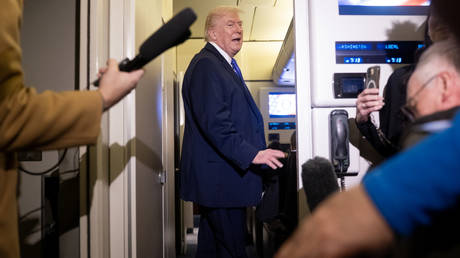 US President Donald Trump talking to journalists aboard Air Force One.