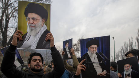 FILE PHOTO: Iranians holding portraits of Supreme Leader Ali Khamenei during a pro-government rally.