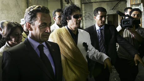 FILE PHOTO: Former French President Nicolas Sarkozy and the late Libyan leader Muammar Gaddafi in Tripoli on July 25, 2007.