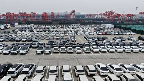 Chinese electric vehicles await export at the dock near the Beijing-Hangzhou Grand Canal, Zhejiang province, China.