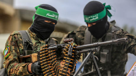 Hamas fighters oversee a hostage exchange in Deir al-Balah, Gaza, February 8, 2025  © Getty Images / Abed Rahim Khatib
