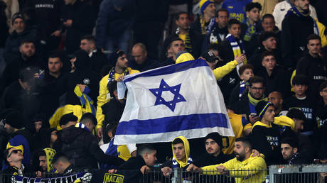 FILE PHOTO. Maccabi Tel-Aviv FC fans display the flag of Israel
