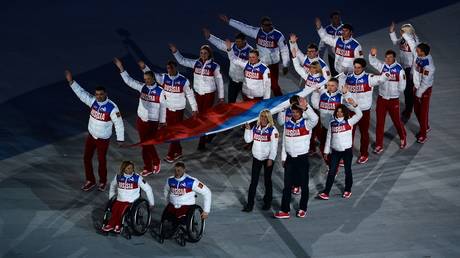 The Russian national flag being carried out at the closing ceremony of the Sochi 2014 Winter Paralympics.