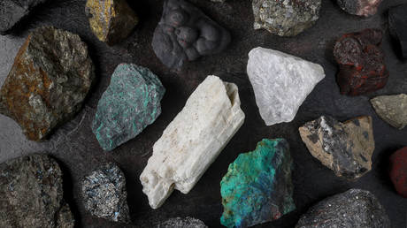 Mixture of critical minerals. Flatlay on slate background.