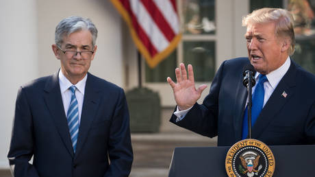 FILE PHOTO: US President Donald Trump (R) and Federal Reserve Chairman Jerome Powell.