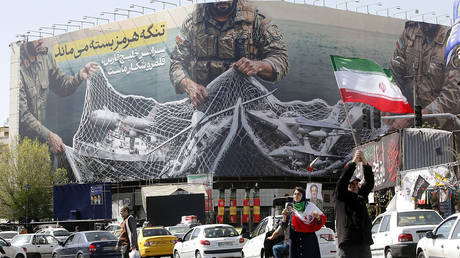 A giant banner in Tehran’s Enghelab Square reads “The Strait of Hormuz will remain closed,” April 5, 2026.