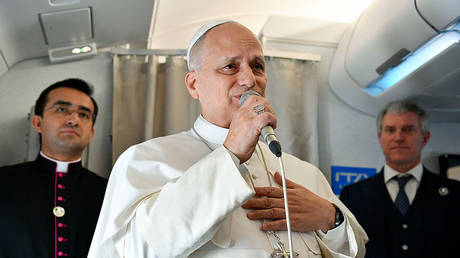 Pope Leo XIV speaks to reporters aboard a flight to Algiers, April 13, 2026.