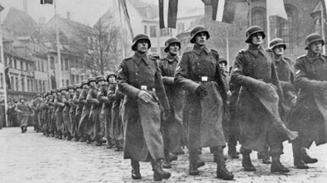 Latvian Legion (Waffen-SS) marching next to Riga Cathedral in Latvia, 1943.