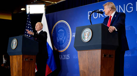Russian President Vladimir Putin, accompanied by US President Donald Trump, speaks during a press conference at Joint Base Elmendorf-Richardson on August 15, 2025 in Anchorage, Alaska.