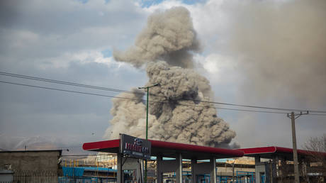A plume of smoke rises over the Tehran skyline after an airstrike amid the US-Israeli military campaign against Iran on March 2, 2026.