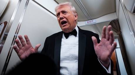 US President Donald Trump speaking to members of the media aboard Air Force One.