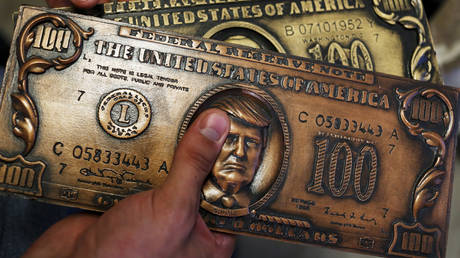FILE PHOTO: A mock money printing plate with US President Donald Trump’s face.