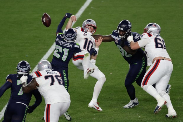 Seattle Seahawks cornerback Devon Witherspoon (21) forces a fumble against New England Patriots quarterback Drake Maye (10) at the NFL Super Bowl 60 game in Santa Clara, Calif., Sunday, February 8, 2026. (Adam Hunger/AP Content Services for the NFL)