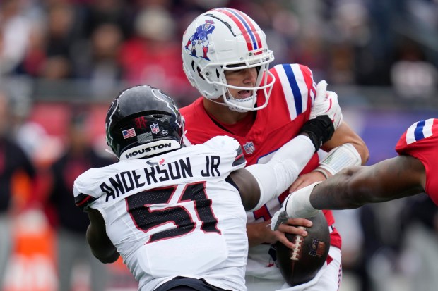 New England Patriots quarterback Drake Maye is sacked by Houston Texans defensive end Will Anderson Jr. (51) during an NFL game on Sunday, Oct. 13, 2024 in Foxboro. (AP Photo/Charles Krupa)