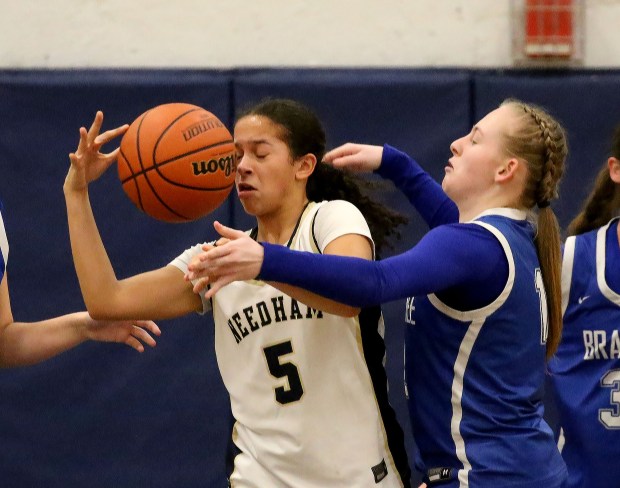 Needham's Lacey Williams (L) looses control of the rebound against Braintree's Audrey Ormsby as Braintree takes on Needham in girls basketball. (Staff photo by Stuart Cahill/Media News Group)