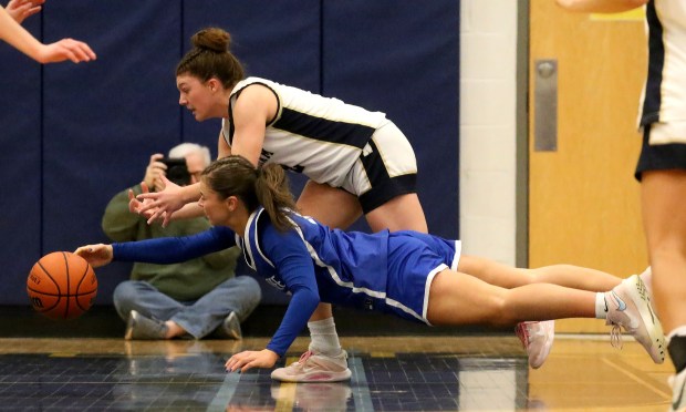 Braintree's Francesca Mazzini dives for the ball in front of Needham's Dani Deroian as Braintree takes on Needham in girls basketball. (Staff photo by Stuart Cahill/Media News Group)