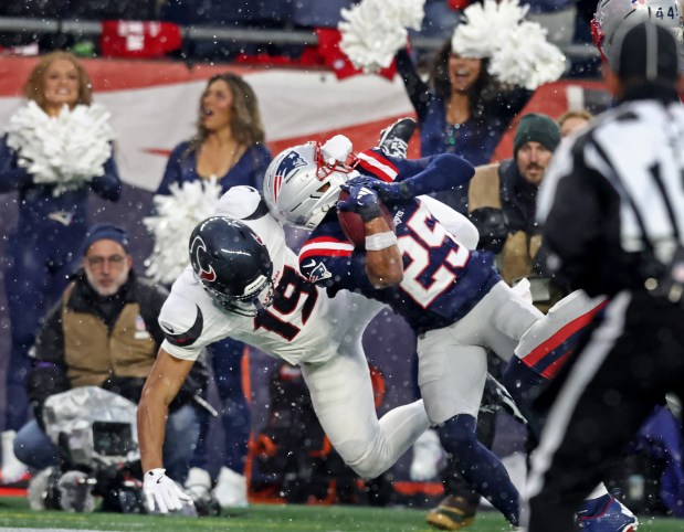 New England Patriots cornerback Marcus Jones scores a pick-six during the second quarter of the divisional-round game at Gillette Stadium. (Nancy Lane/Boston Herald)