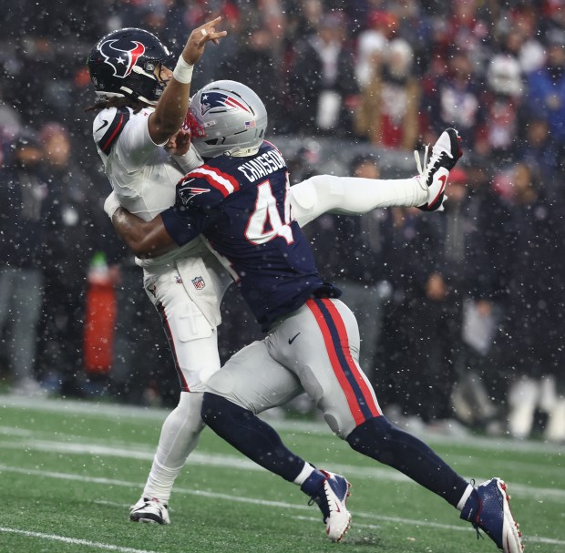 New England Patriots linebacker K'Lavon Chaisson pressures Houston Texans quarterback C.J. Stroud into throwing a pick-six during the second quarter of the divisional-round game at Gillette Stadium. (Nancy Lane/Boston Herald)