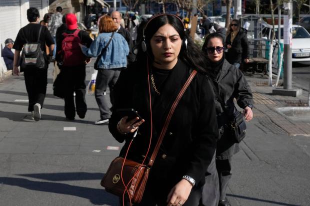 People walk on a sidewalk