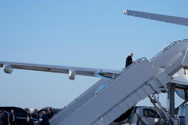 President Donald Trump boards Air Force One, Sunday, Feb. 1, 2026, at Palm Beach International Airport in West Palm Beach, Fla. (AP Photo/Mark Schiefelbein)
