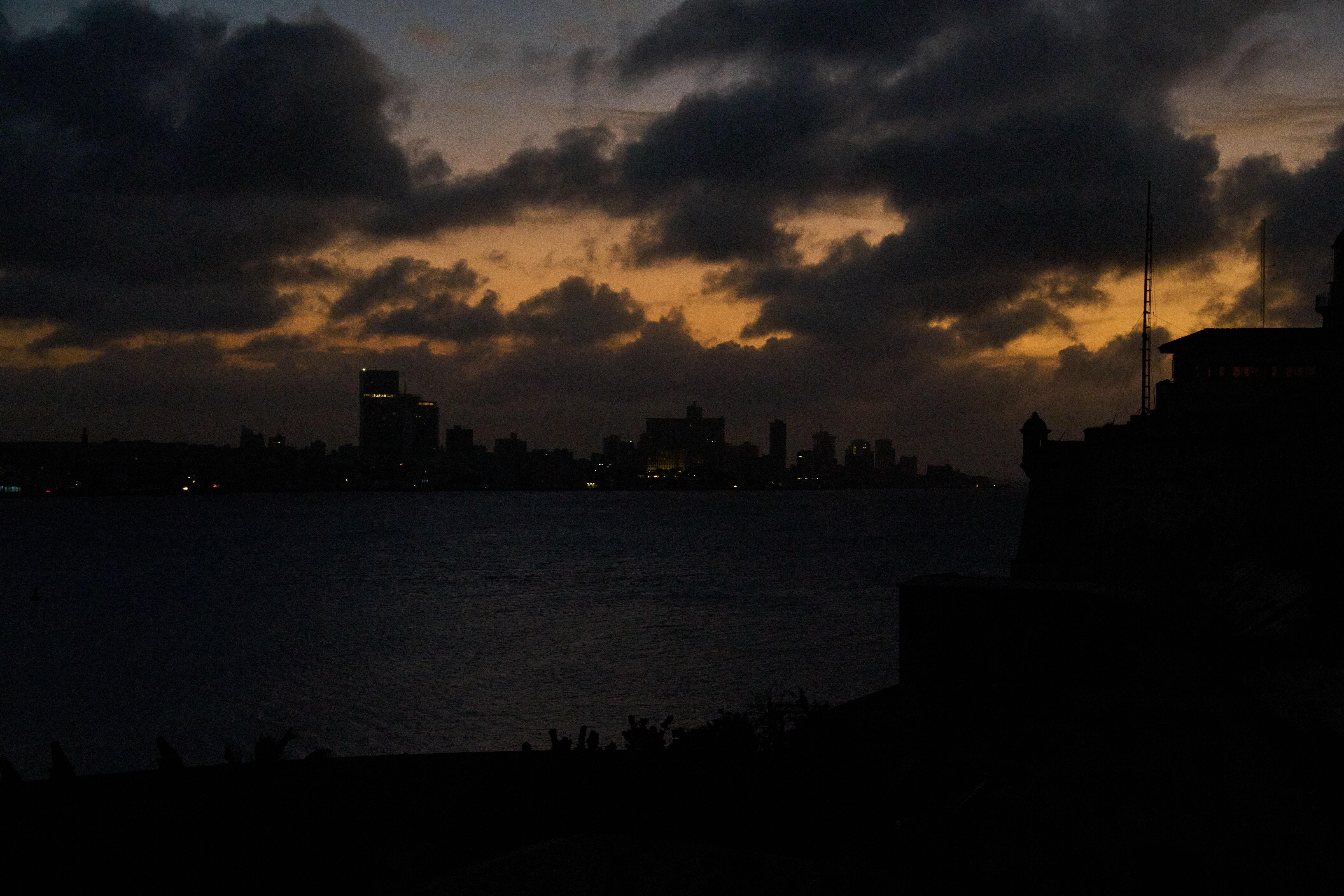Clouds gather above Havana during a blackout, Wednesday, March 4,...