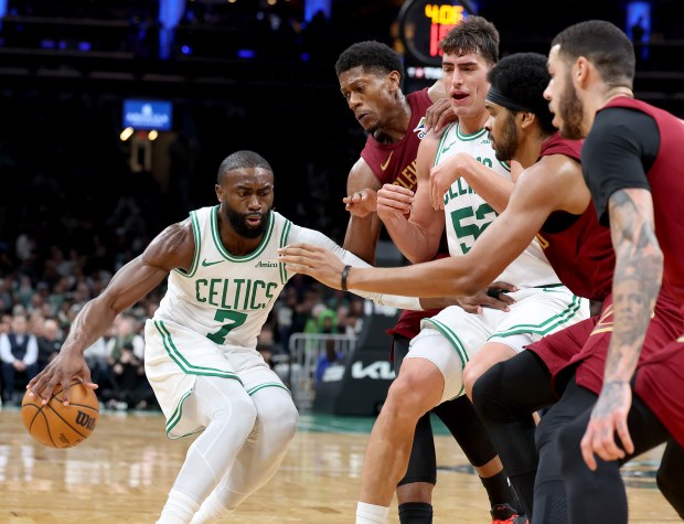 Boston Celtics guard Jaylen Brown (7) and center Luka Garza (52) defend the ball from a trio of Cleveland Cavaliers defenders during the first half of an NBA game earlier this season in Boston. (Mark Stockwell/Boston Herald)