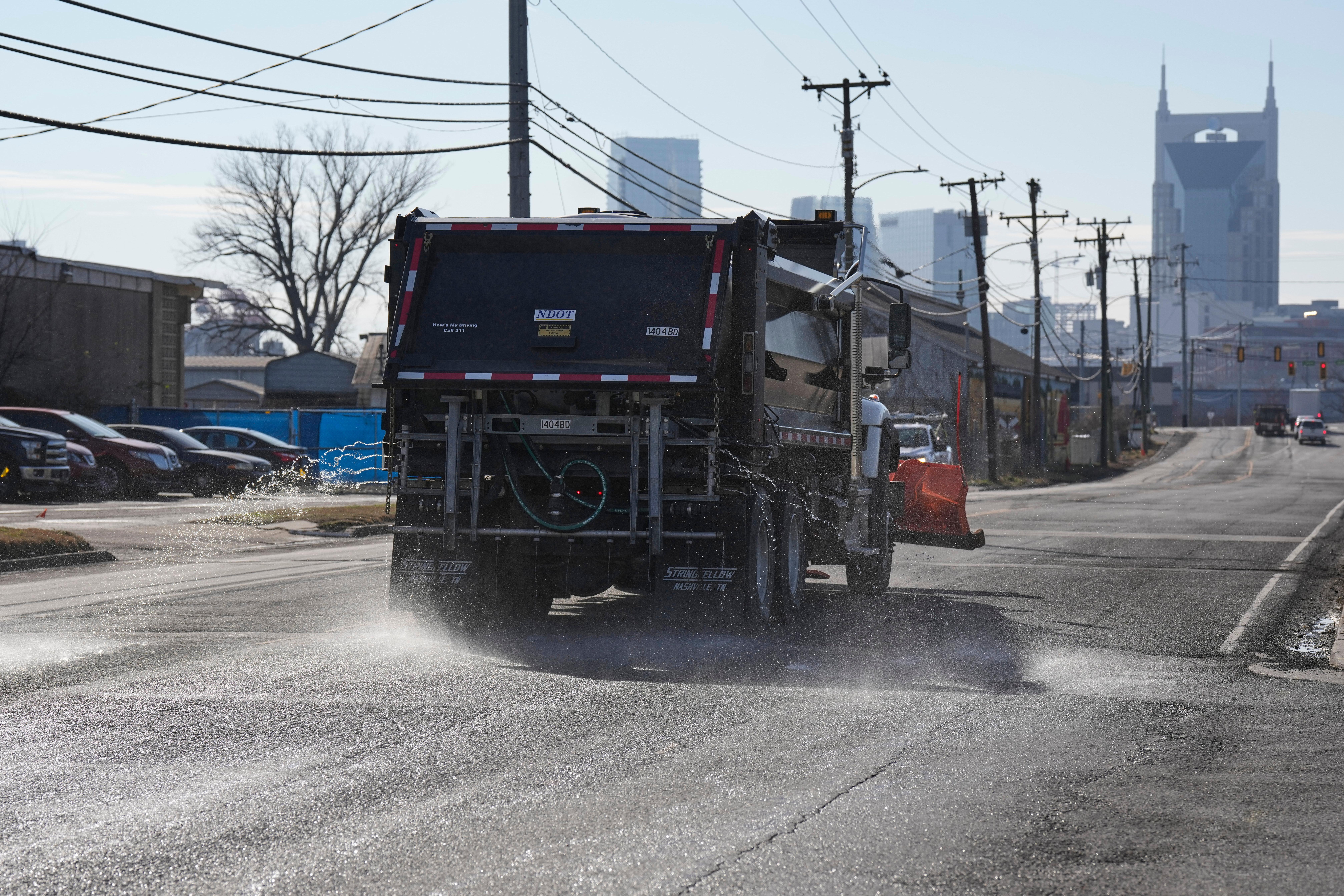 A Nashville Department of Transportation truck applies salt brine to...