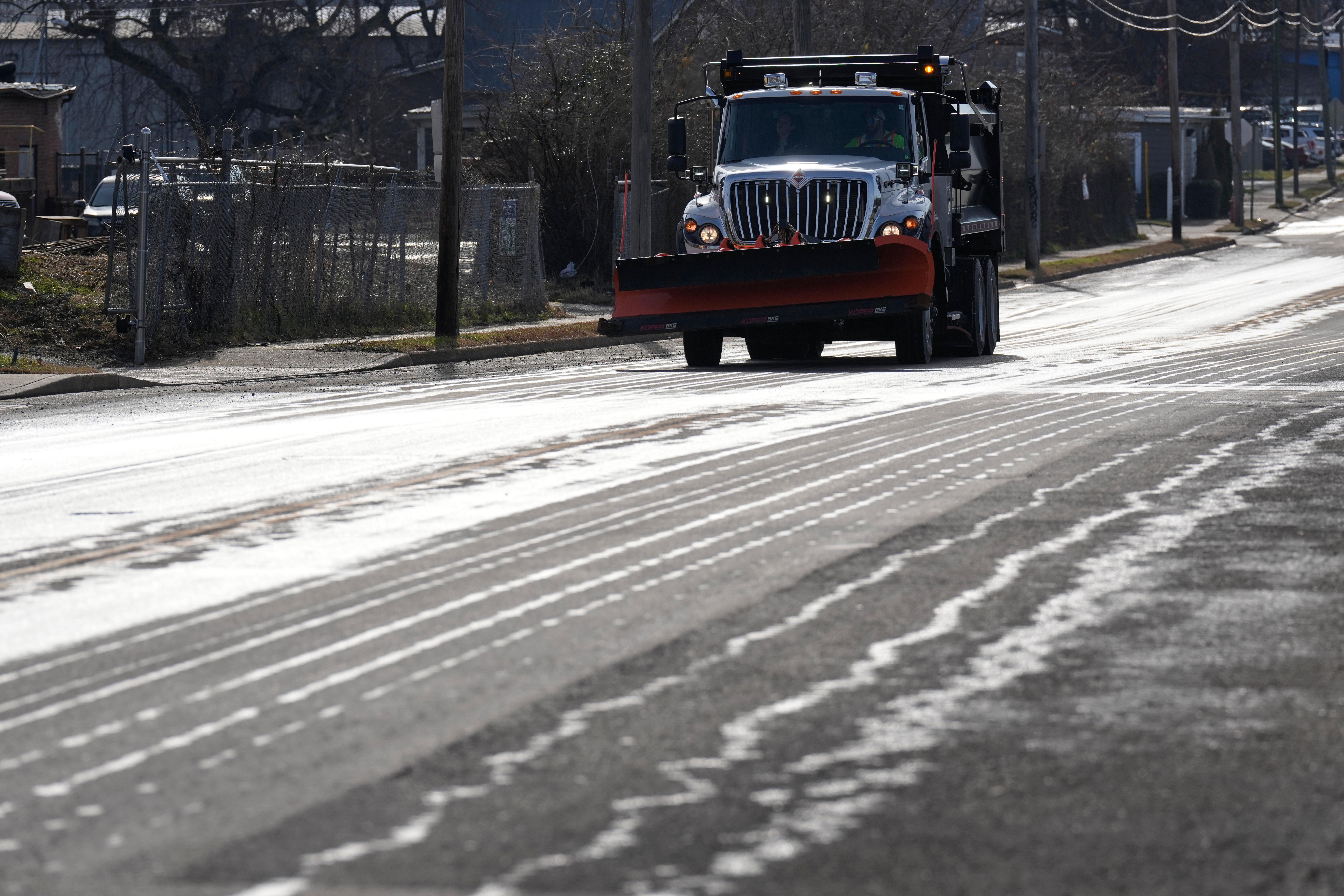 A Nashville Department of Transportation truck applies salt brine to...