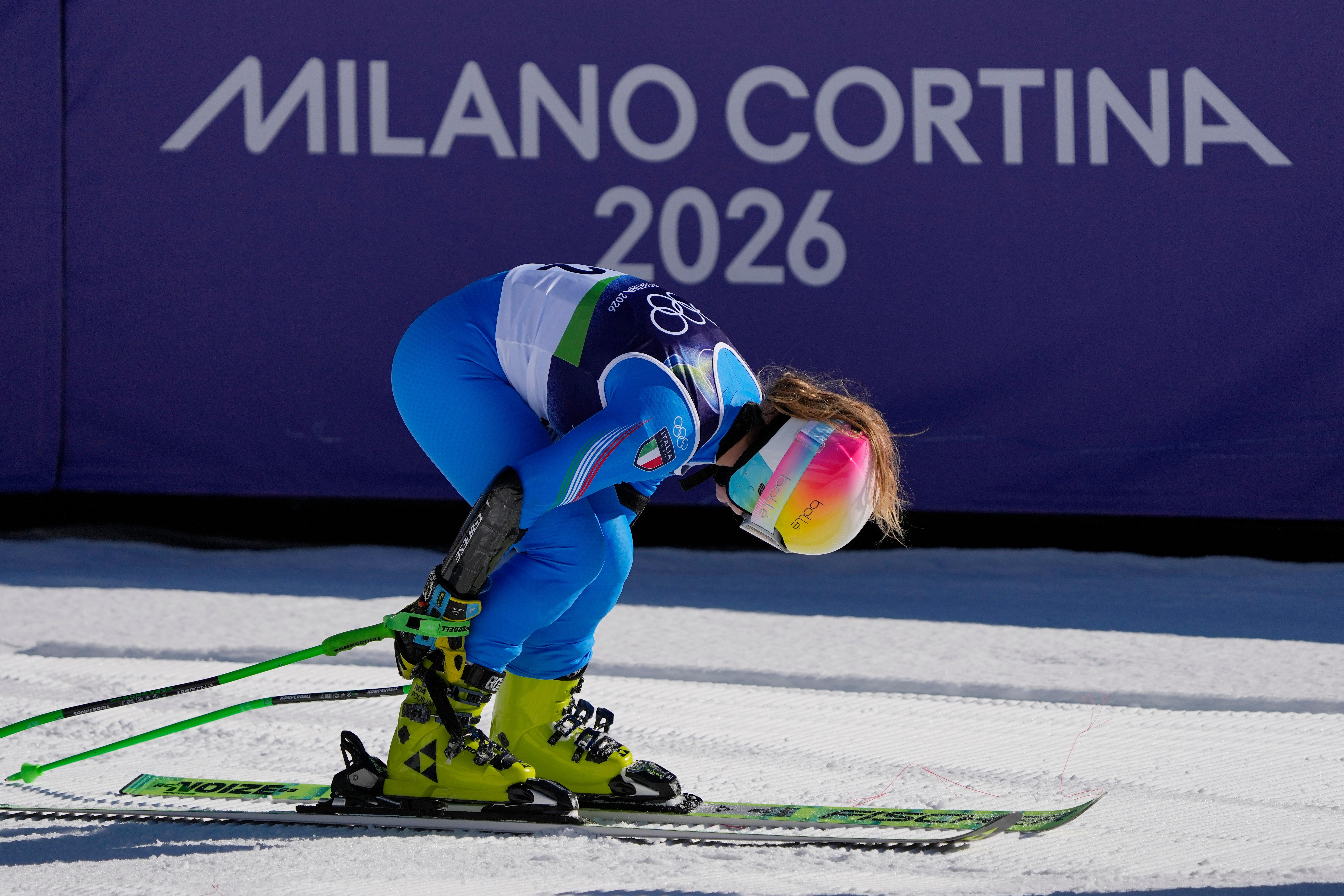 Italy’s Lara Della Mea unlatches her boots at the finish...