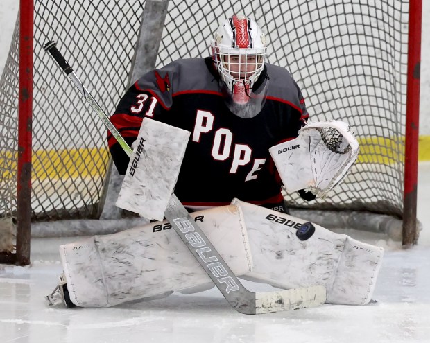 Pope Francis goalie George Ramsey makes a glove save during a 6-0 win over Braintree. (Mark Stockwell/Boston Herald)