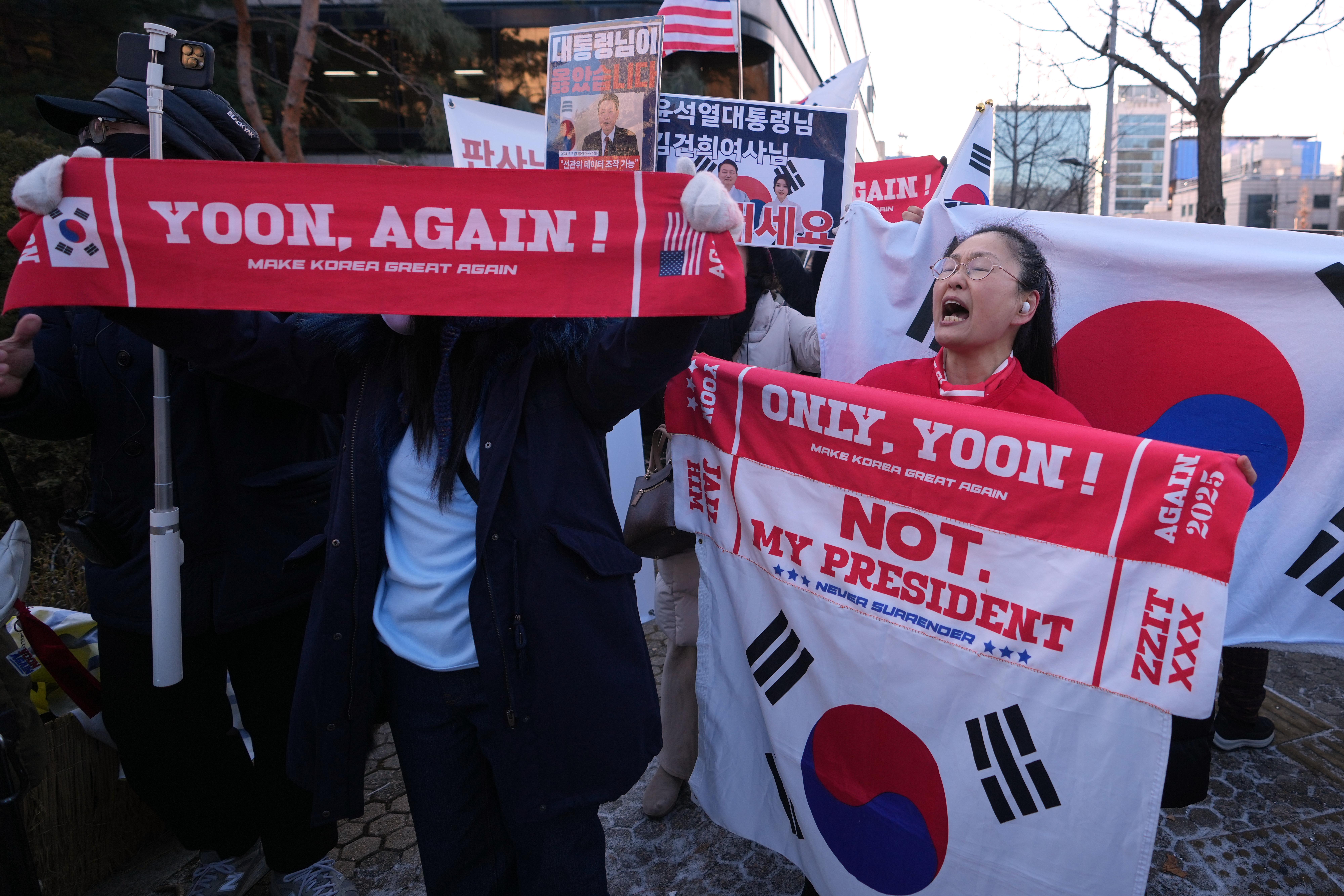 Supporters of former South Korean President Yoon Suk Yeol hold...