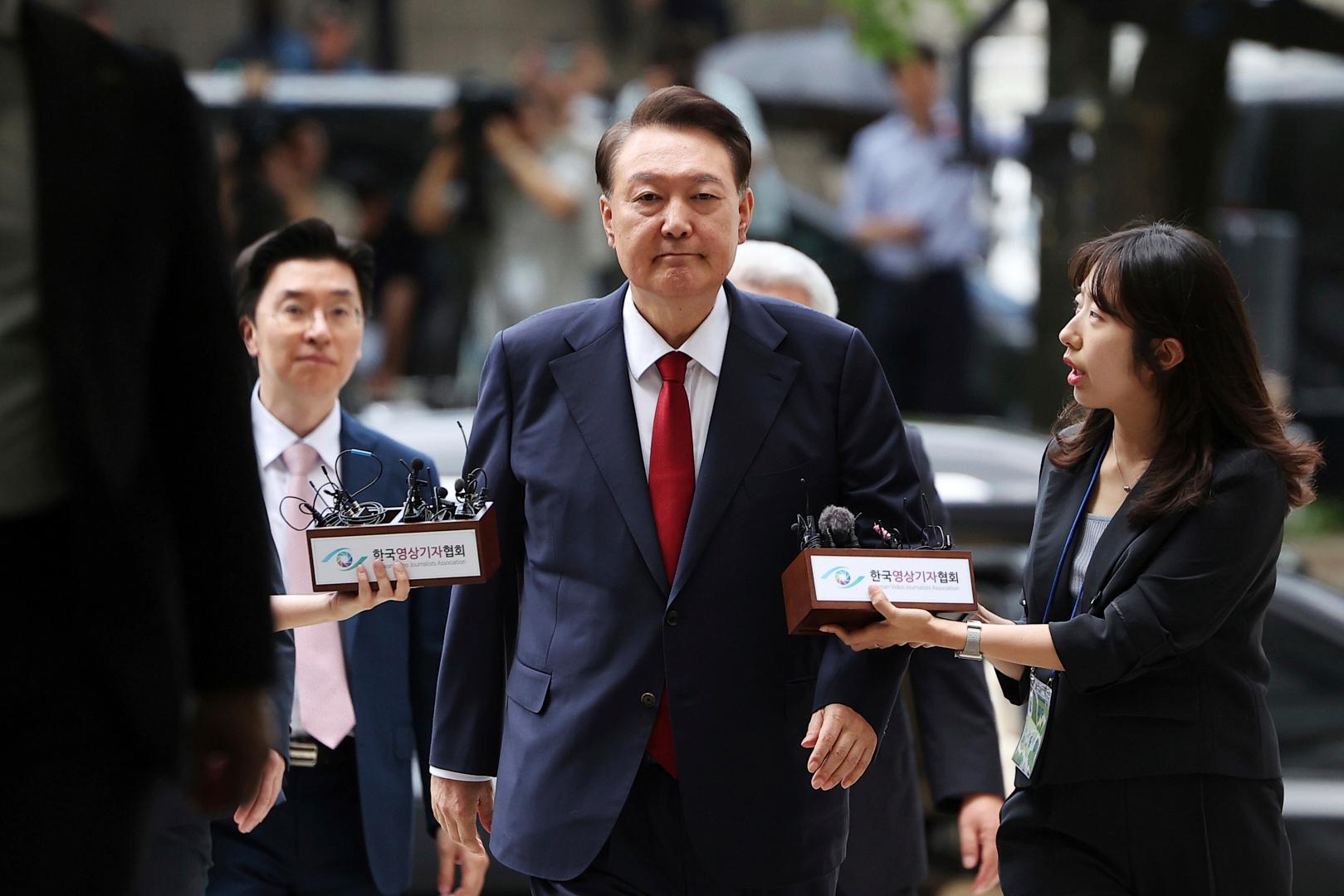FILE – Former South Korean President Yoon Suk Yeol, center,...