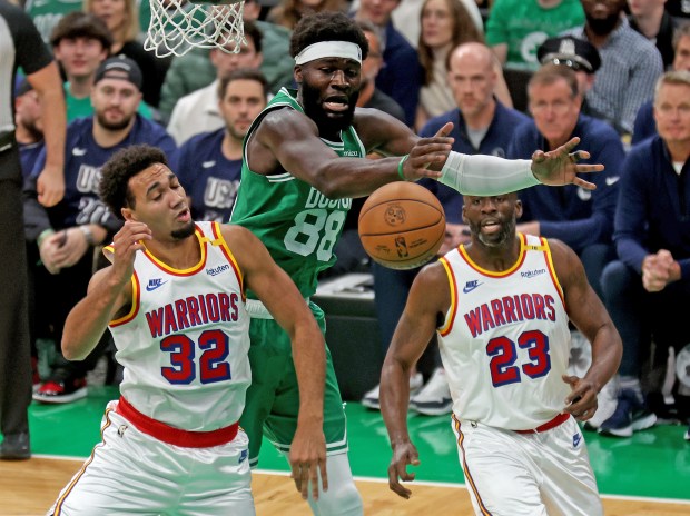 Neemias Queta of the Boston Celtics rebounds against Trayce Jackson-Davis and Draymond Green (23) of the Golden State Warriors during the first half of the NBA game. (Photo By Matt Stone/Boston Herald)