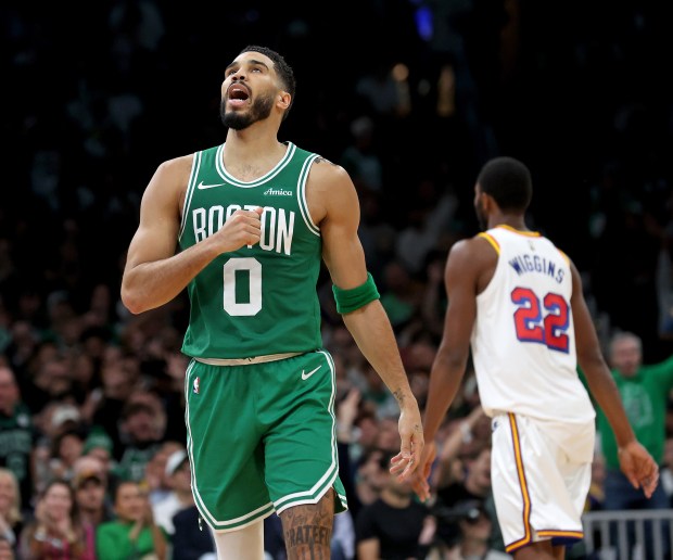 Jayson Tatum of the Boston Celtics celebrates as Andrew Wiggins of the Golden State Warriors walks off during the first half. (Photo By Matt Stone/Boston Herald)