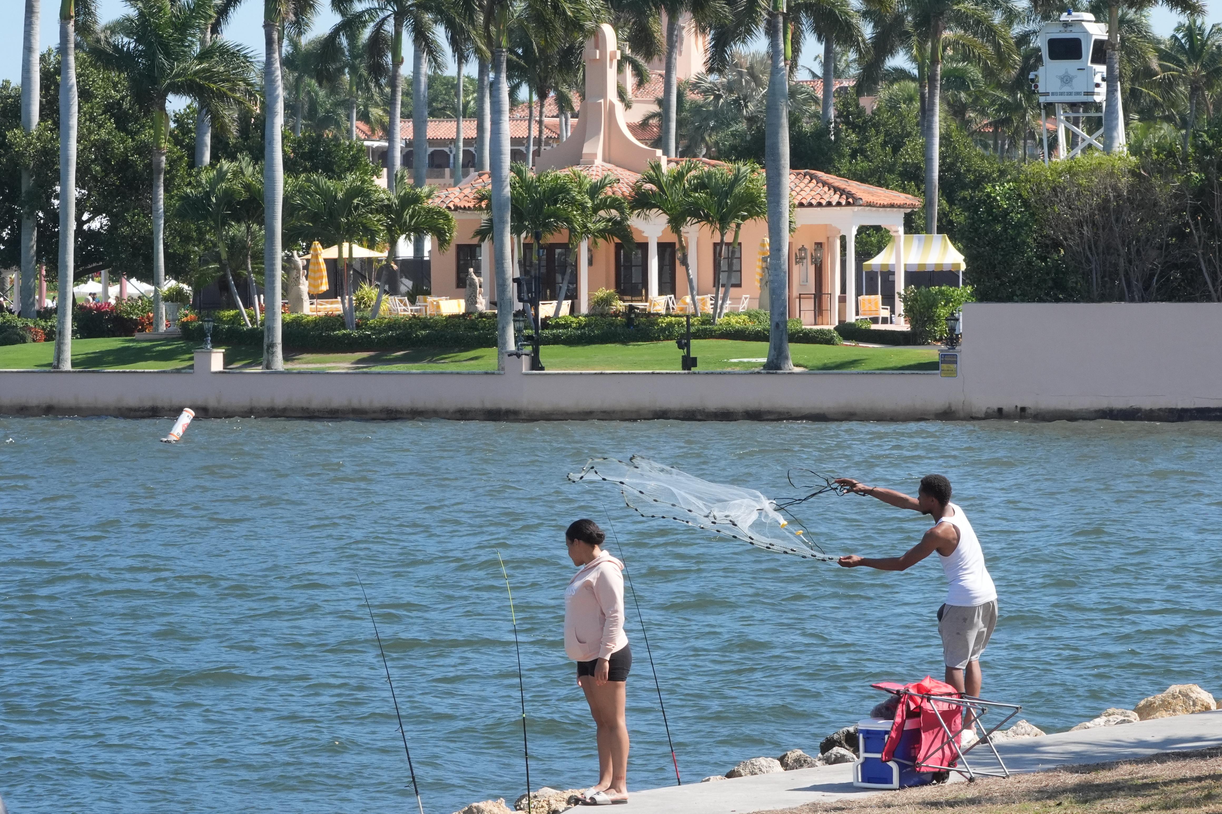 A fisherman casts his neat near Mar-a-Lago Sunday, Feb. 22,...