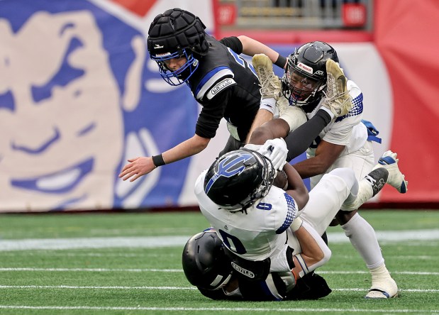 Randolph's Alin Norisca is tackled by West Boylston's Luke Lewis during the first half in Foxboro. Randolph won the Div. 8 state title with a 21-0 win. (Photo By Matt Stone/Boston Herald)