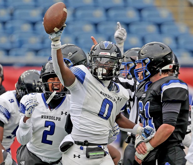Randolph's Alin Norisca holds the ball up in celebration after recovering a fumble against West Boylston during the second half of the Div. 8 Super Bowl. Randolph won, 21-0. (Photo By Matt Stone/Boston Herald)