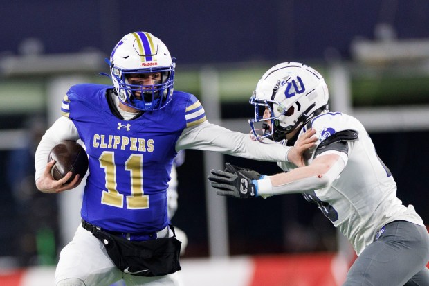 Norwell's Jack Luccarelli, left, tries to avoid Fairhaven's Grant Darmofai during the first half. Fairhaven won 28-14 to claim the Div. 6 Super Bowl. (CJ Gunther/Boston Herald)