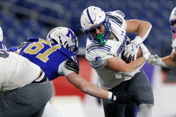 Norwell's George Bonnevie, left, tackles Fairhaven's Ian Alexion during the first half. Fairhaven won the Div. 6 state title with a 28-14 victory. (CJ Gunther/Boston Herald)