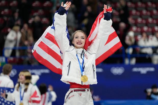 Team USA's Amber Glenn celebrates with her gold medal after the figure skating team event.