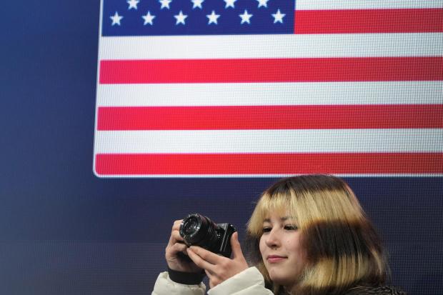 Alysa Liu of the United States takes photos at the 2026 Winter Olympics.