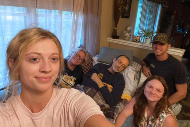 Amiya Tennant takes a family photo with her mom, Becky; dad, Eric; brother, Arryn; and sister-in-law, Jaimee, at her parents' home in Bridgeport, West Virginia. (Amiya Tennant/Amiya Tennant/TNS)