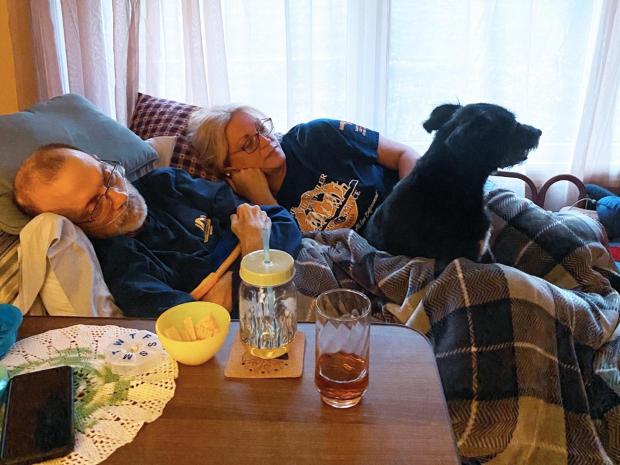 Eric and Becky Tennant rest in Eric's hospice bed with their dog, Molly. Eric died at home of cancer on Sept. 17. (Amiya Tennant/Amiya Tennant/TNS)
