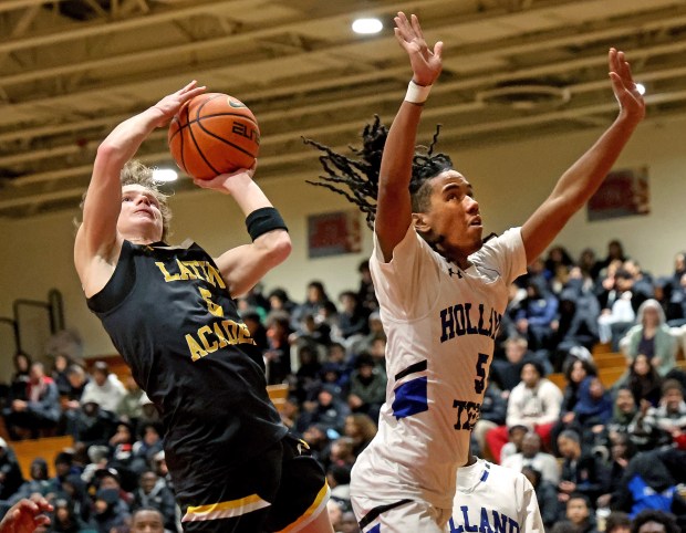 Latin Academy's Will Olinto shoots around Holland's Kingston Mills during the first half of a boys Boston City League championship basketball game at Madison Park High. (Photo By Matt Stone/Boston Herald)
